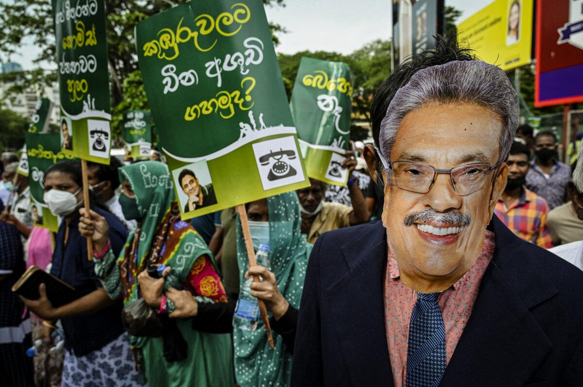 A Sri Lankan activist wearing a mask of Sri Lanka's President Gotabaya Rajapaksa takes part in a demonstration to denounce the shortage of commodities as the country faces a major foreign exchange crisis, in Colombo, Sri Lanka, on Nov. 16, 2021. (ISHARA S. KODIKARA/AFP via Getty Images)