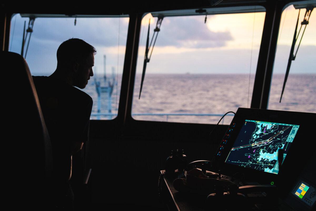 Chief Officer Jason Garwood studies a maritime map as he and his team take Falkor (too) into the Atlantic. (Courtesy of Alex Ingle/ Schmidt Ocean Institute)