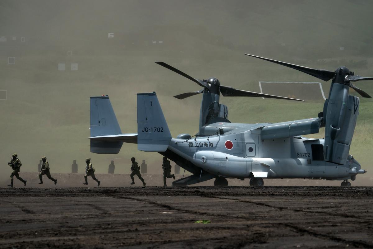 Members of the Japan Ground Self-Defense Force (JGSDF) disembark from a V-22 Osprey aircraft during a live fire exercise at East Fuji Maneuver Area in Gotemba, Shizuoka, Japan, on May 28, 2022. (Tomohiro Ohsumi/Getty Images)