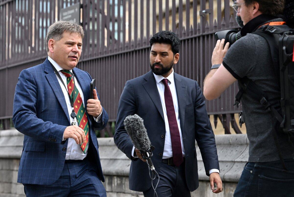 Conservative MP for North West Leicestershire, Andrew Bridgen (L) is interviewed by a TV journalist as he walks outside the Houses of Parliament in central London on July 6, 2022. (Justin Tallis/AFP via Getty Images)