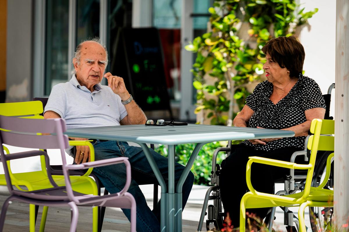 Seniors sit outside a cafe in West Palm Beach, Fla., on March 12, 2020. (Eva Marie Uzcategui/AFP via Getty Images)