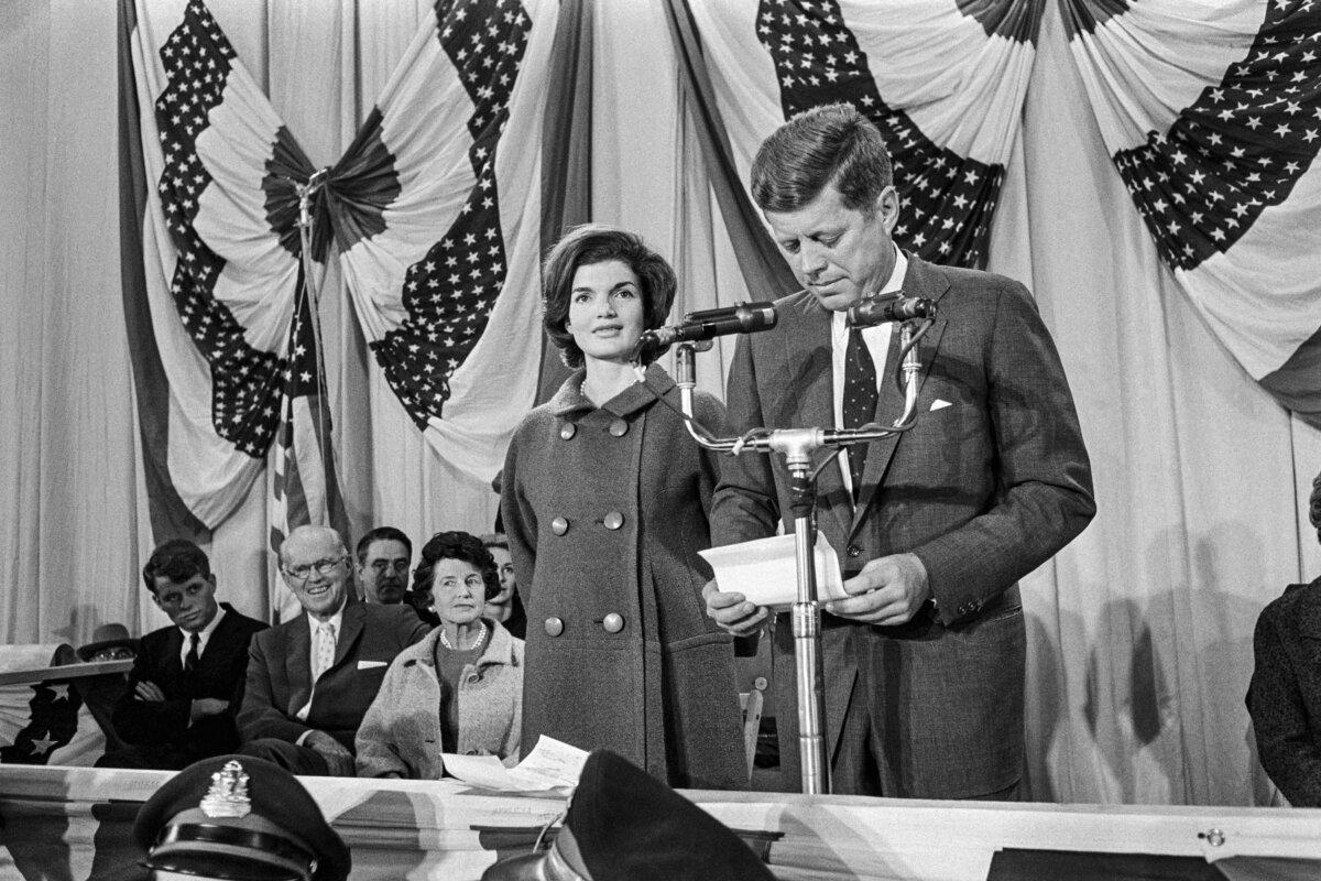 First lady Jacqueline Kennedy (C) stands next to President-elect John Fitzgerald Kennedy as he delivers his victory speech on Nov. 9, 1960. She was only 31 years old when her husband took office. (AFP via Getty Images)