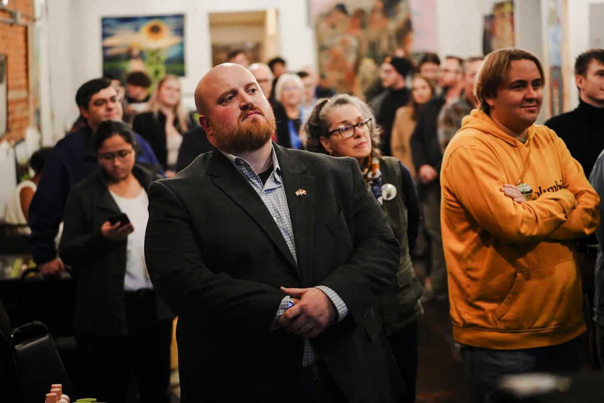 West Virginia U.S. Senate candidate Zach Shrewsbury (C), a Democrat, is surrounded by supporters at an event in Morgantown, W.V., on Nov. 29, 2023. (Madalina Vasiliu/The Epoch Times)