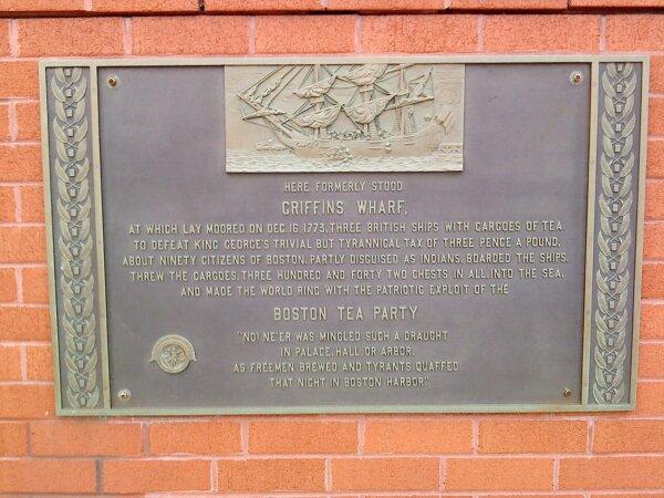A plaque commemorating the Boston Tea Party, currently affixed to side of the Independence Wharf Building in Boston. (Public Domain)