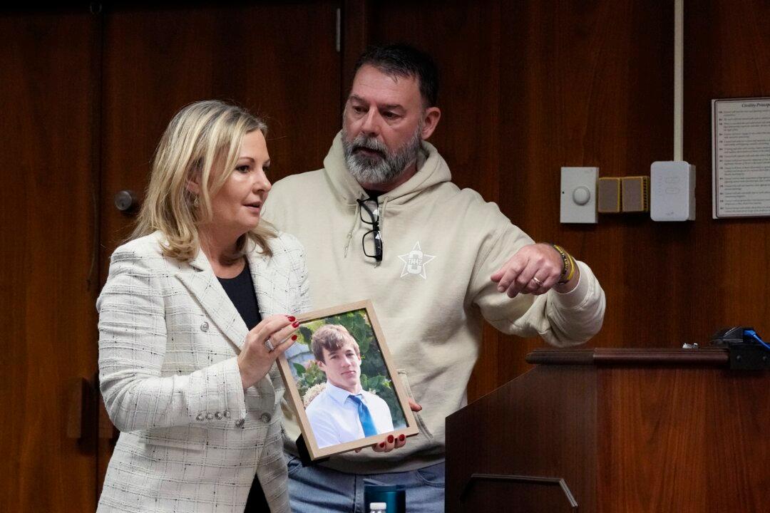 Oakland County prosecutor Karen McDonald stands next to Buck Myre, the father of Tate Myre, before his victim impact statement in Pontiac, Mich., on Dec. 8, 2023. (Carlos Osorio/AP Photo)