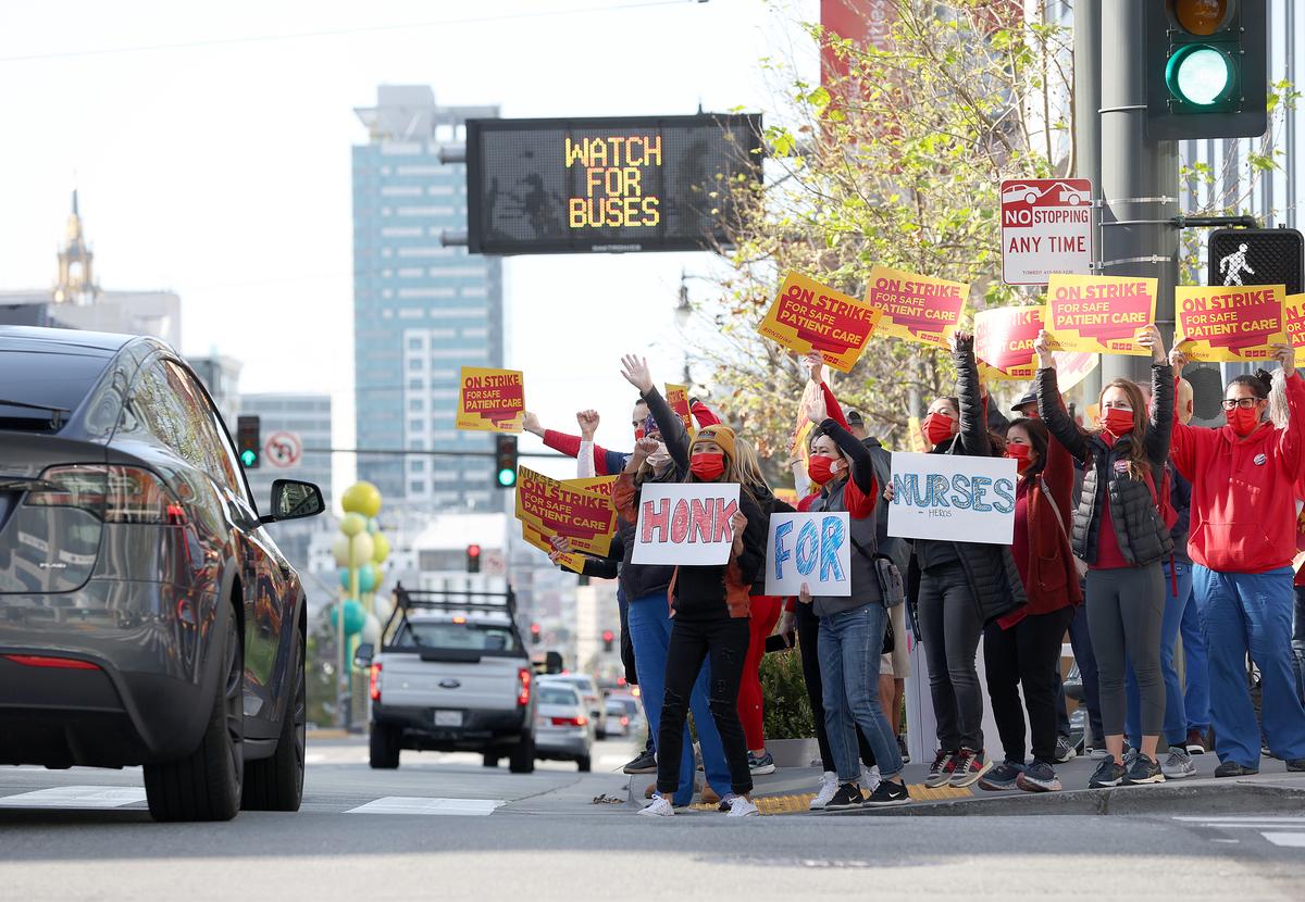 Sutter Health nurses and health care workers hold signs during a one-day strike outside of the California Pacific Medical Center Van Ness Campus in San Francisco on April 18, 2022. (Justin Sullivan/Getty Images)