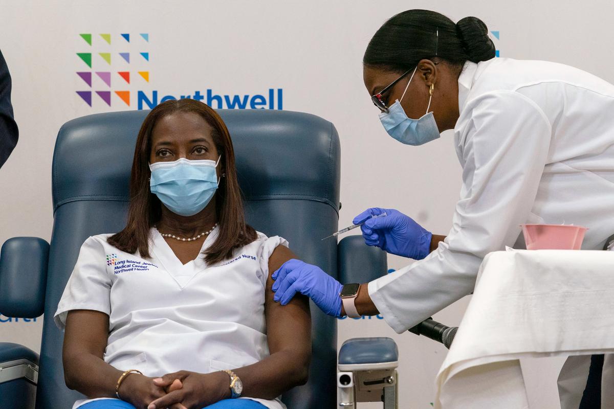 A nurse at the Long Island Jewish Medical Center is injected with the COVID-19 vaccine in Queens, N.Y., on Dec. 14, 2020. (Mark Lennihan - Pool/Getty Images)