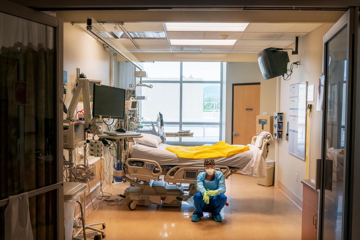 A nurse at Asante Three Rivers Medical Center waits for her next COVID-19 patient to be brought from the emergency room shortly after a deceased patient was removed from the room in Grants Pass, Ore., on Sept. 9, 2021. (Nathan Howard/Getty Images)