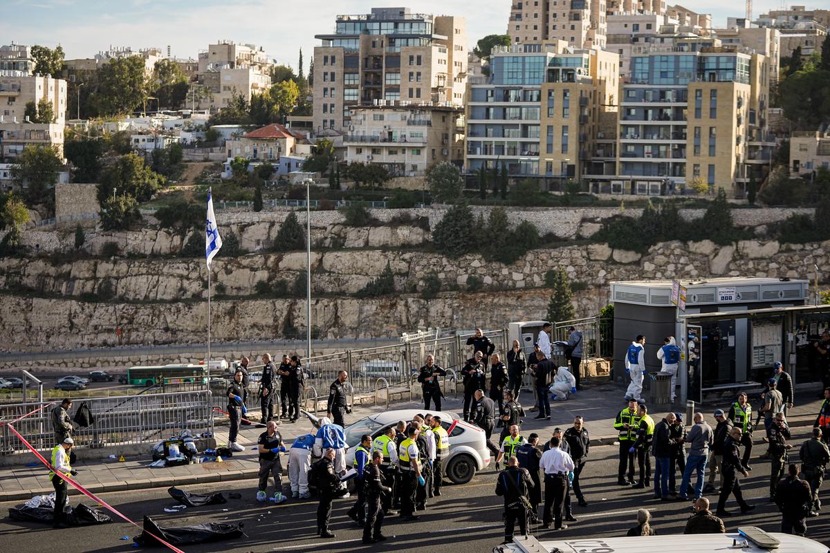 Israeli police officers and volunteer rescue workers at the scene of a shooting in Jerusalem on Nov. 30, 2023. (AP Photo/Ohad Zwigenberg, File)