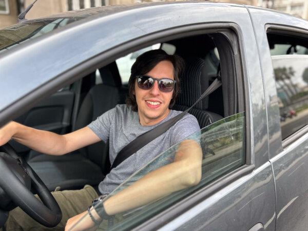 Carlos Eduardo, 34, in the car he uses to work as a driver in Buenos Aires, Argentina, on Dec. 9, 2023. Argentines have reported needing to work two jobs to make a living. (Marcos Schotgues/The Epoch Times)