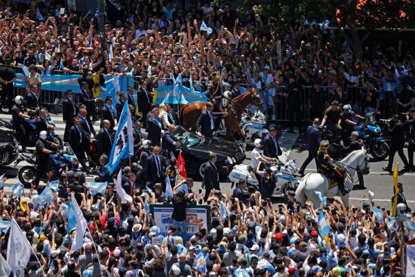 Argentina's new president, Javier Milei, and his sister, Karina Milei, wave to the crowd on their way to Casa Rosada Presidential Palace in an open car after he was sworn in during an inauguration ceremony at the Congress in Buenos Aires on Dec. 10, 2023. (Alejandro Pagni/AFP via Getty Images)