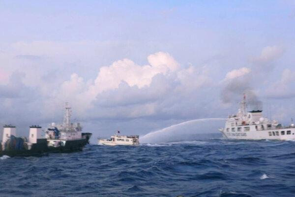 A Chinese Coast Guard ship uses water cannons on Philippine navy-operated supply boat M/L Kalayaan as it approaches Second Thomas Shoal, locally known as Ayungin Shoal, in the disputed South China Sea on Dec. 10, 2023. (Philippine Coast Guard via AP)