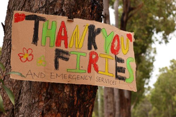 A sign is seen pinned to a tree in Mundaring reading "Thank you Firies and Emergency Services!" in Perth, Australia, on Feb. 6, 2021. (Paul Kane/Getty Images)