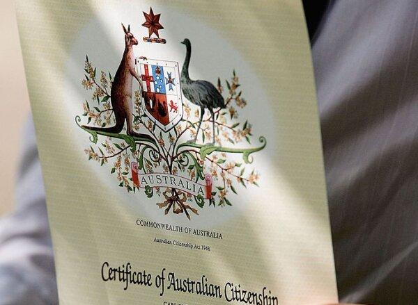 A new Australian citizen holds his certificate after a citizenship ceremony on Australia Day in Sydney, Australia, on Jan. 26, 2006. (Ian Waldie/Getty Images)