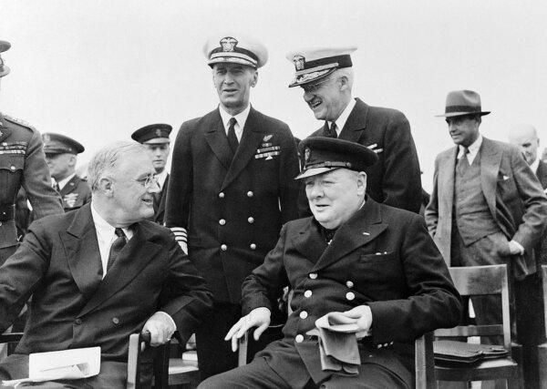 President Roosevelt and Winston Churchill seated on the quarterdeck of HMS Prubce of Wales during the Atlantic Conference, 10 August 1941. (Public Domain)