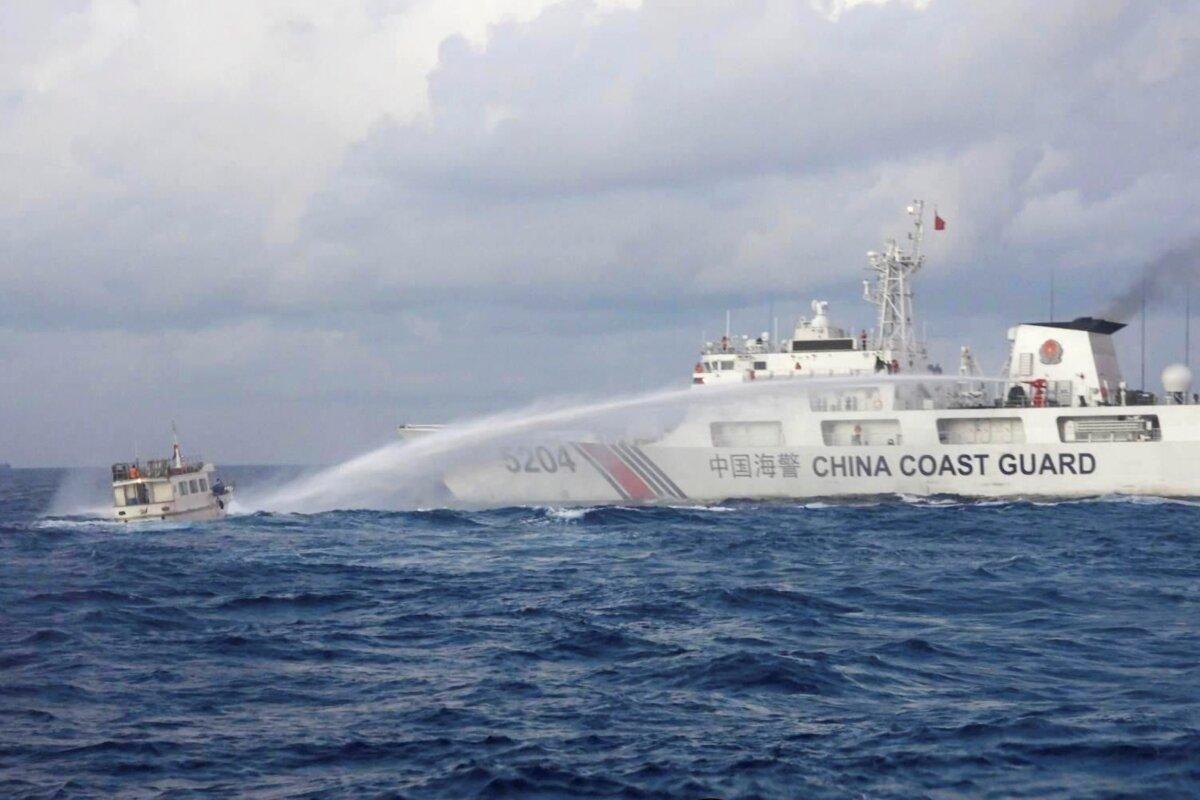 A China Coast Guard ship uses water cannons on Philippine navy-operated supply boat M/L Kalayaan as it approaches Second Thomas Shoal, locally known as Ayungin Shoal, in the disputed South China Sea, on Dec. 10, 2023. (Philippine Coast Guard via AP)