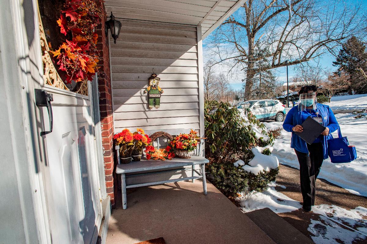 A nurse undertaking mobile vaccinations arrives at the home of a patient in Manchester, Connecticut, on Feb. 12, 2021. (Joseph Prezioso/AFP via Getty Images)