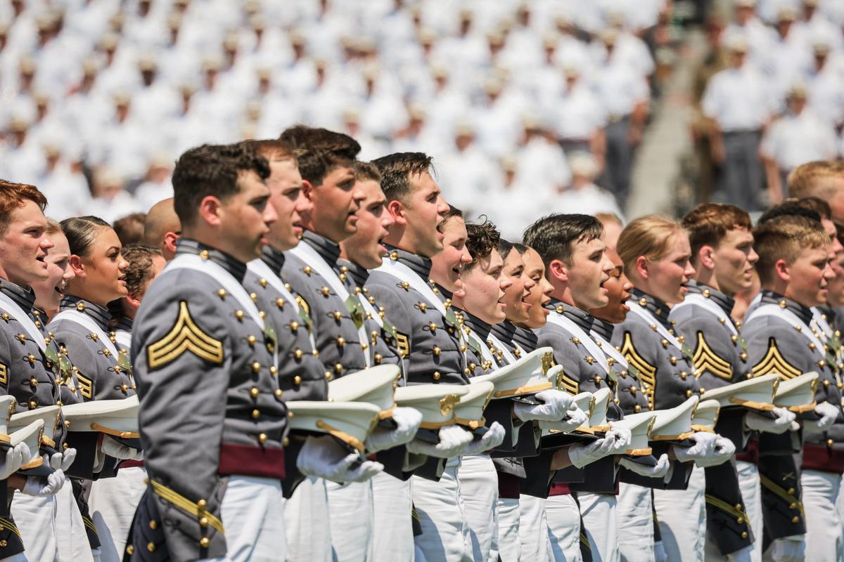  West Point graduates stand and sing the Army Song during the 2022 West Point Commencement Ceremony at West Point Military Academy in West Point, N.Y., on May 21, 2022. (Michael M. Santiago/Getty Images)