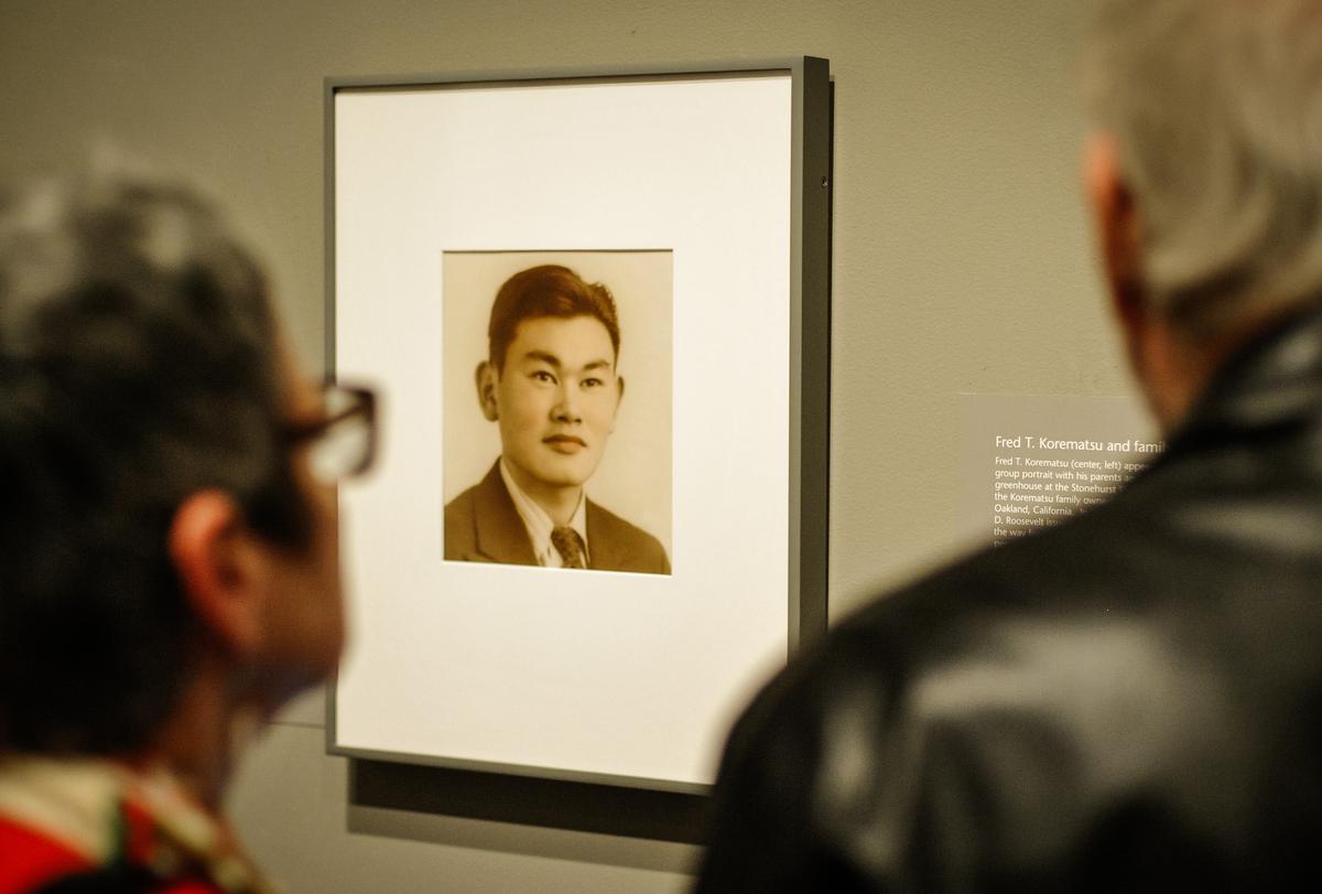 Guests look at a photograph of Fred Korematsu during a presentation of his portrait to the National Portrait Gallery in Washington on Feb. 2, 2012. (Mandel Ngan/AFP via Getty Images)