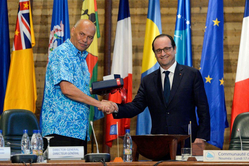 Former French President Francois Hollande (R) shakes hands with then-general director of the Secretariat of the Pacific Community (SPC) Colin Tukuitonga (L) during a meeting in Noumea, New Caledonia on Nov. 17, 2014. (Fred Payet/AFP via Getty Images)
