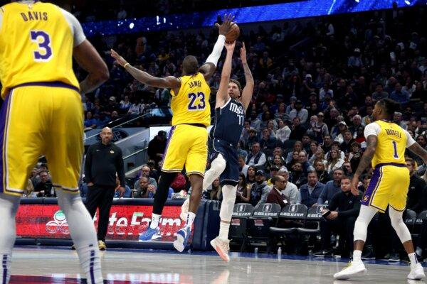 Luka Doncic (77) of the Dallas Mavericks shoots the ball against LeBron James (23) of the Los Angeles Lakers in the second half in Dallas on Dec. 12, 2023. (Tim Heitman/Getty Images)