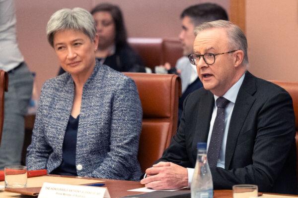 Australia's Prime Minister Anthony Albanese (R) speaks as he sits next to Australia's Minister for Foreign Affairs Penny Wong in Parliament House in Canberra, Australia, on Dec. 7, 2023. (<span style="font-weight: 400;">Hilary Wardhaugh</span>/AFP via Getty Images)