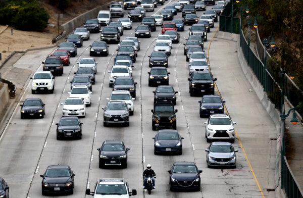 Vehicles make their way down the aging 110 freeway toward downtown Los Angeles during the morning commute on April 22, 2021. President Joe Biden pledged to cut U.S. greenhouse gas emissions in half by 2030 at the Earth Day climate summit. (Mario Tama/Getty Images)