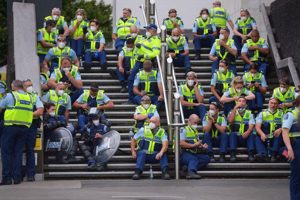 Police rest as protesters against COVID-19 vaccine mandates and restrictions gathered near parliament grounds in Wellington, New Zealand on March 2, 2022. (Dave Lintott/AFP via Getty Images)