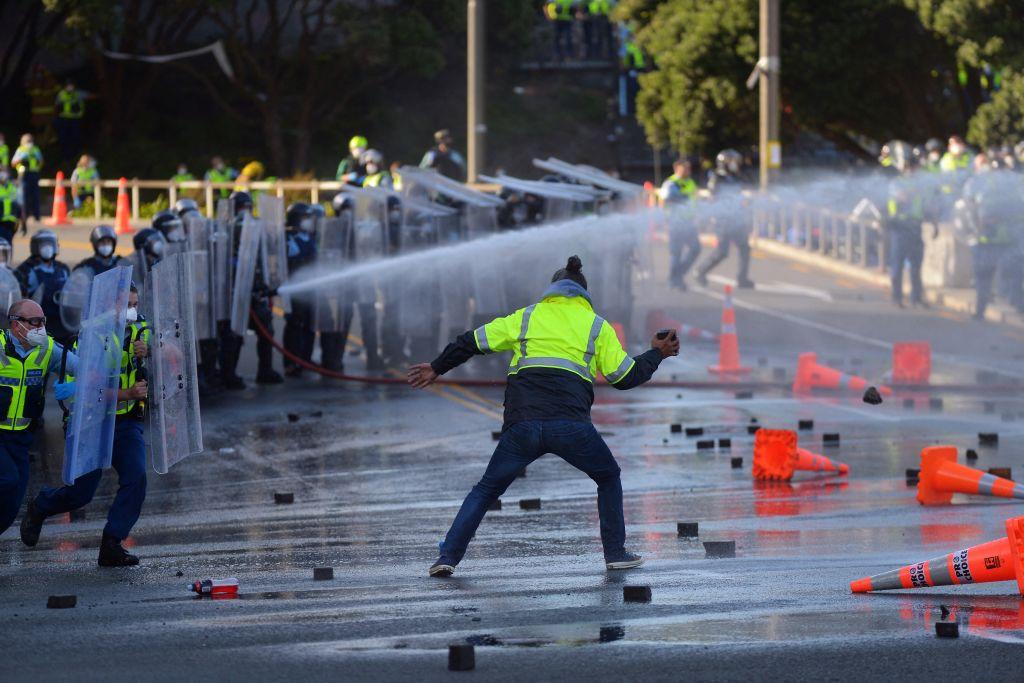 A man faces off with police near the Parliament as law enforcement move in to clear protesters in Wellington, New Zealand on March 2, 2022. (Dave Lintott/AFP via Getty Images)