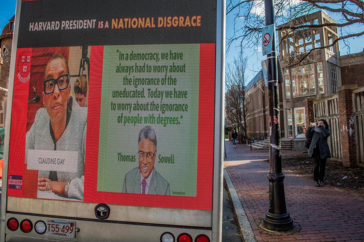 A truck displaying a sign calling the president of Harvard a disgrace drives around Harvard University in Cambridge, Mass., on Dec. 12, 2023. (Joseph Prezioso/AFP via Getty Images)