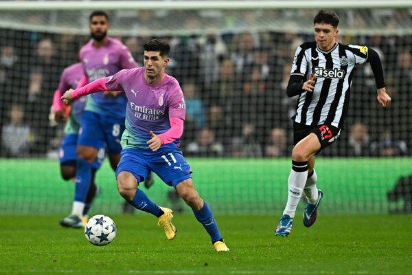 American forward (11) Christian Pulisic of AC Milan dribbles the ball against Newcastle United during a UEFA Champions League Group F match at St James' Park in Newcastle-upon-Tyne, north east England on Dec. 13, 2023. (Paul Ellis/AFP via Getty Images)