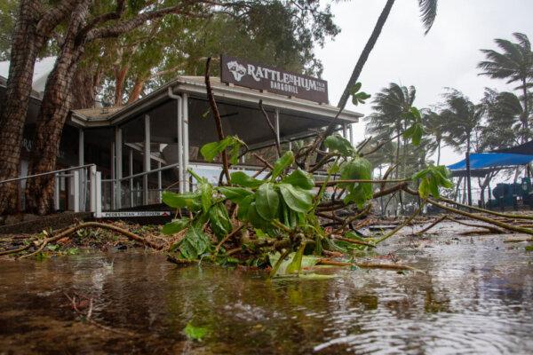 A bar-restaurant is seen past fallen branches in Palm Cove as Cyclone Jasper approaches landfall near Cairns in far north Queensland on Dec. 13, 2023. (Brian Cassey/AFP via Getty Images)