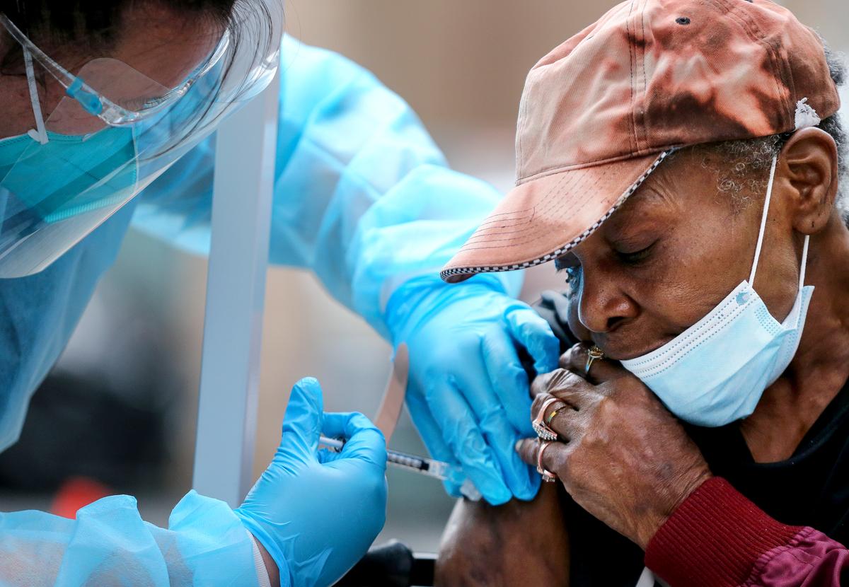  Viola, 75, receives a dose of the Moderna COVID-19 vaccine from a healthcare worker located in the Skid Row community in Los Angeles on Feb. 10, 2021. (Mario Tama/Getty Images)
