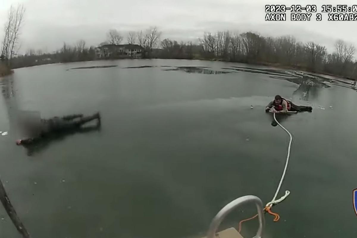One of the men crawls ashore while Deputy Fjeld is pulled back toward the dock. (Courtesy of Anoka County Sheriff's Office)