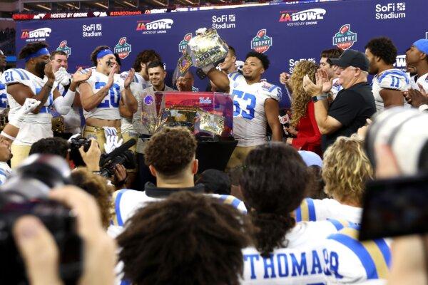 Darius Muasau (53) of the UCLA Bruins celebrates the win with teammates on stage during the Starco Brands LA Bowl Hosted by Gronk in Inglewood, Calif., on Dec. 16, 2023. (Katelyn Mulcahy/Getty Images)