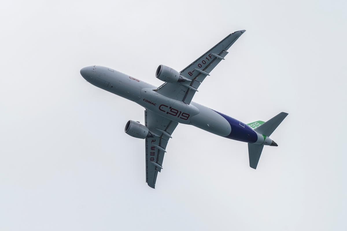 China’s C919 passenger plane flies over Victoria Harbor for a demonstration, on Dec. 16, 2023, in Hong Kong. (Yu Gang/The Epoch Times)