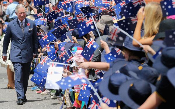 Schoolchildren wave Australian flags as then-Prince Charles, Prince of Wales visits Kilkenny Primary School in Adelaide, Australia, on Nov. 7, 2012. (Chris Jackson/Getty Images)