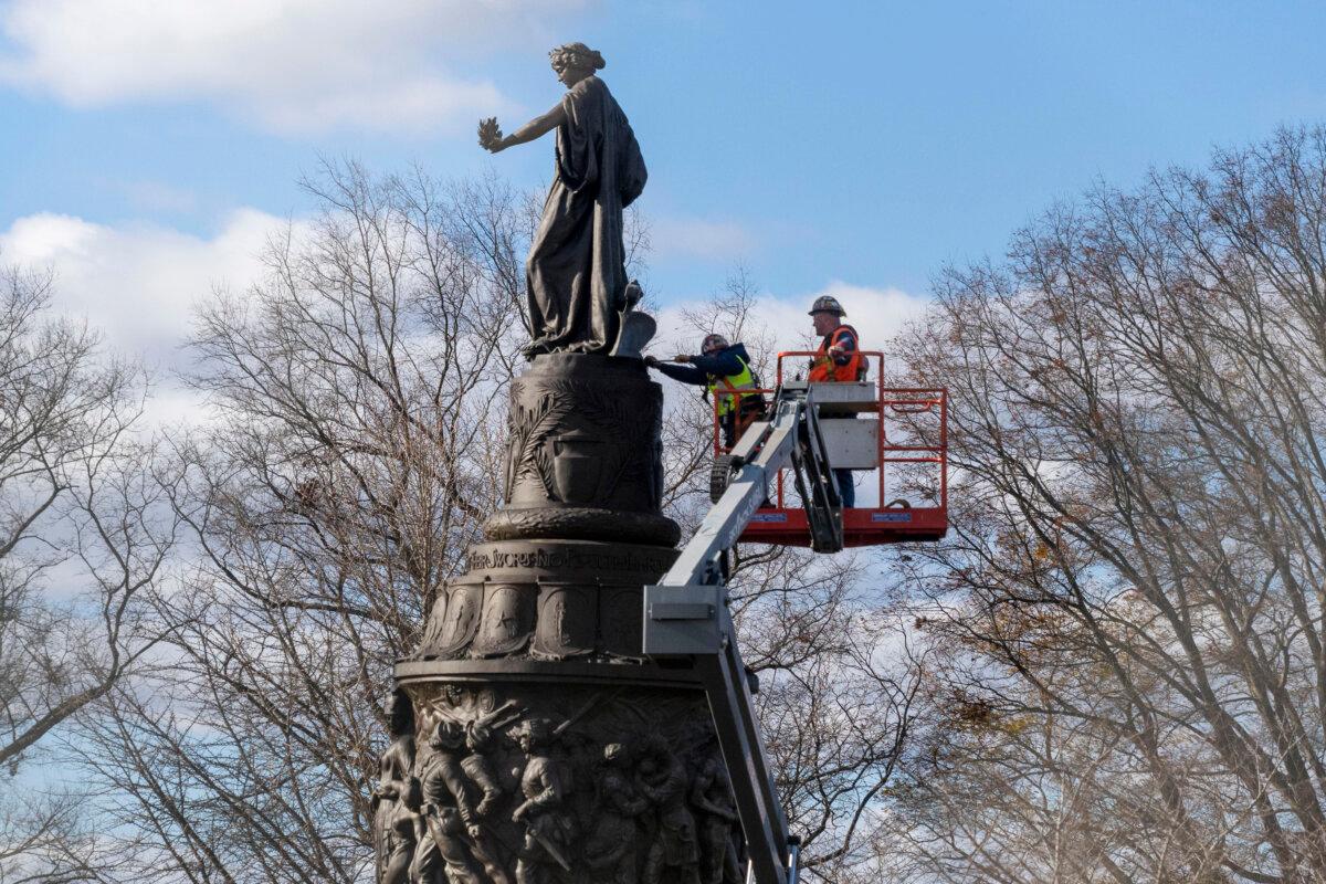 Workers prepare a Confederate Memorial for removal in Arlington National Cemetery in Arlington, Va., on Dec. 18, 2023. (Kevin Wolf/AP Photo)