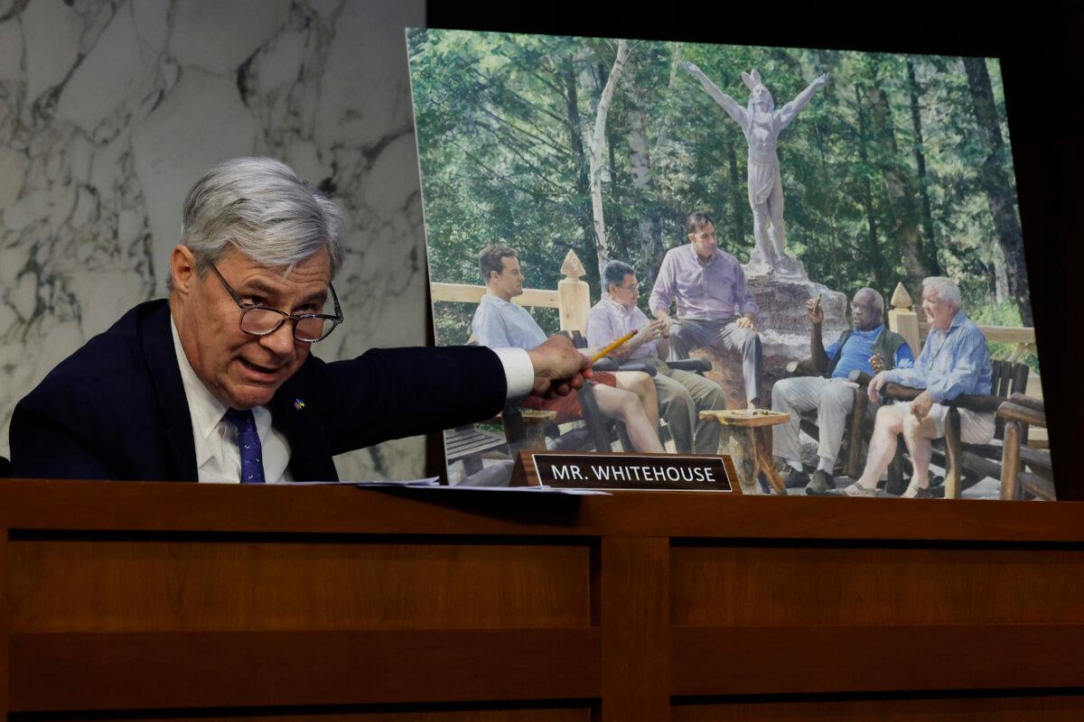 Senate Judiciary Committee member Sen. Sheldon Whitehouse (D-R.I.) displays a copy of a painting featuring Supreme Court Associate Justice Clarence Thomas alongside other conservative leaders during a hearing on Supreme Court ethics reform in the Hart Senate Office Building on Capitol Hill in Washington on May 2, 2023. (Chip Somodevilla/Getty Images)