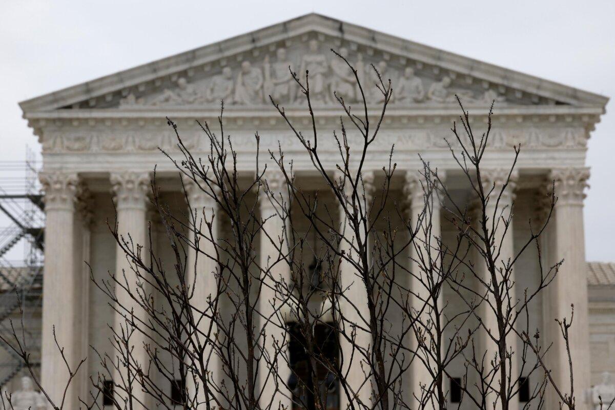Branches slightly obscure the facade of the U.S. Supreme Court building in Washington on April 7, 2023. (Chip Somodevilla/Getty Images)