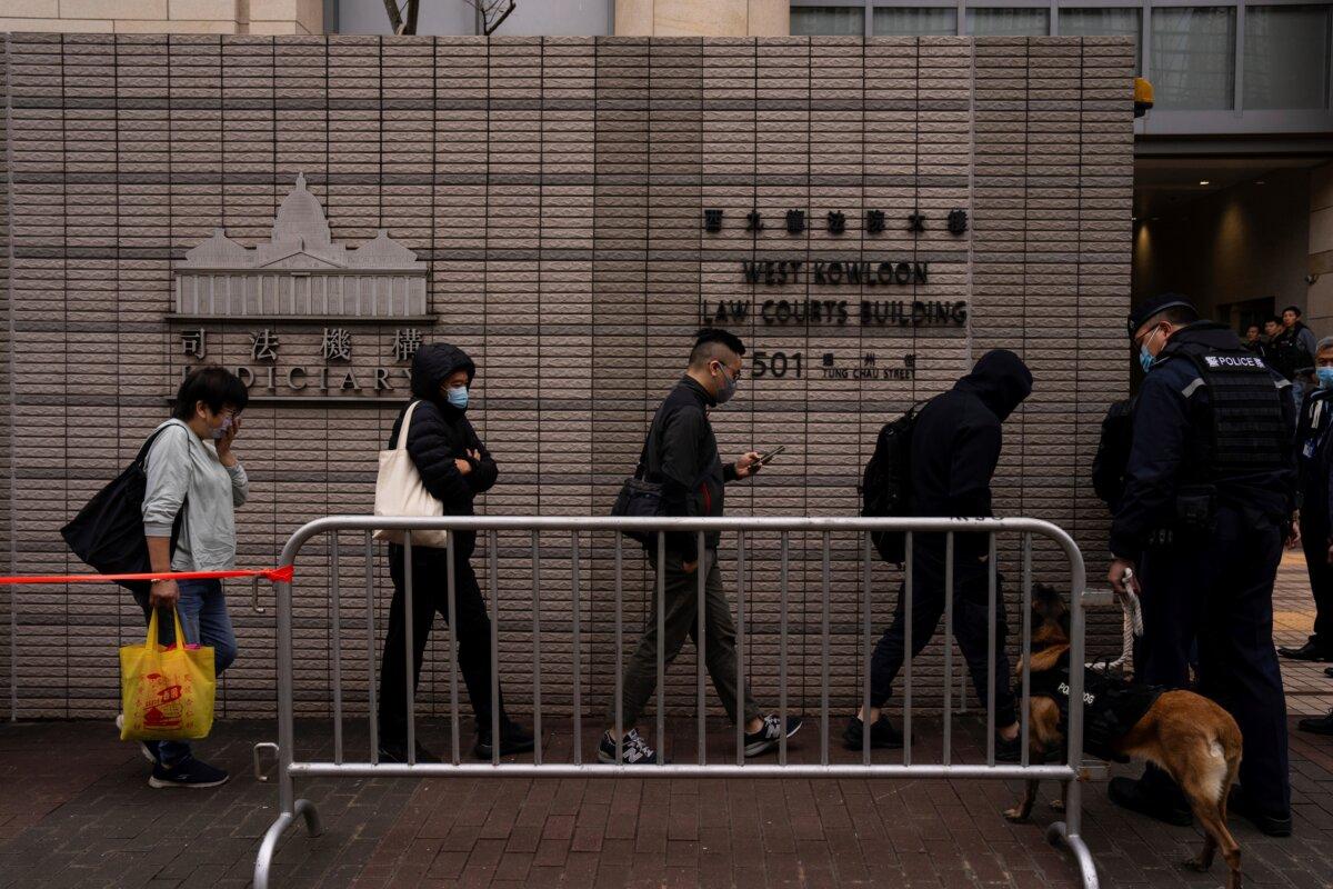 Members of the public line up to enter the West Kowloon Magistrates' Courts, where activist publisher Jimmy Lai's trial takes place, in Hong Kong on Dec. 19, 2023. (Louise Delmotte/AP Photo)
