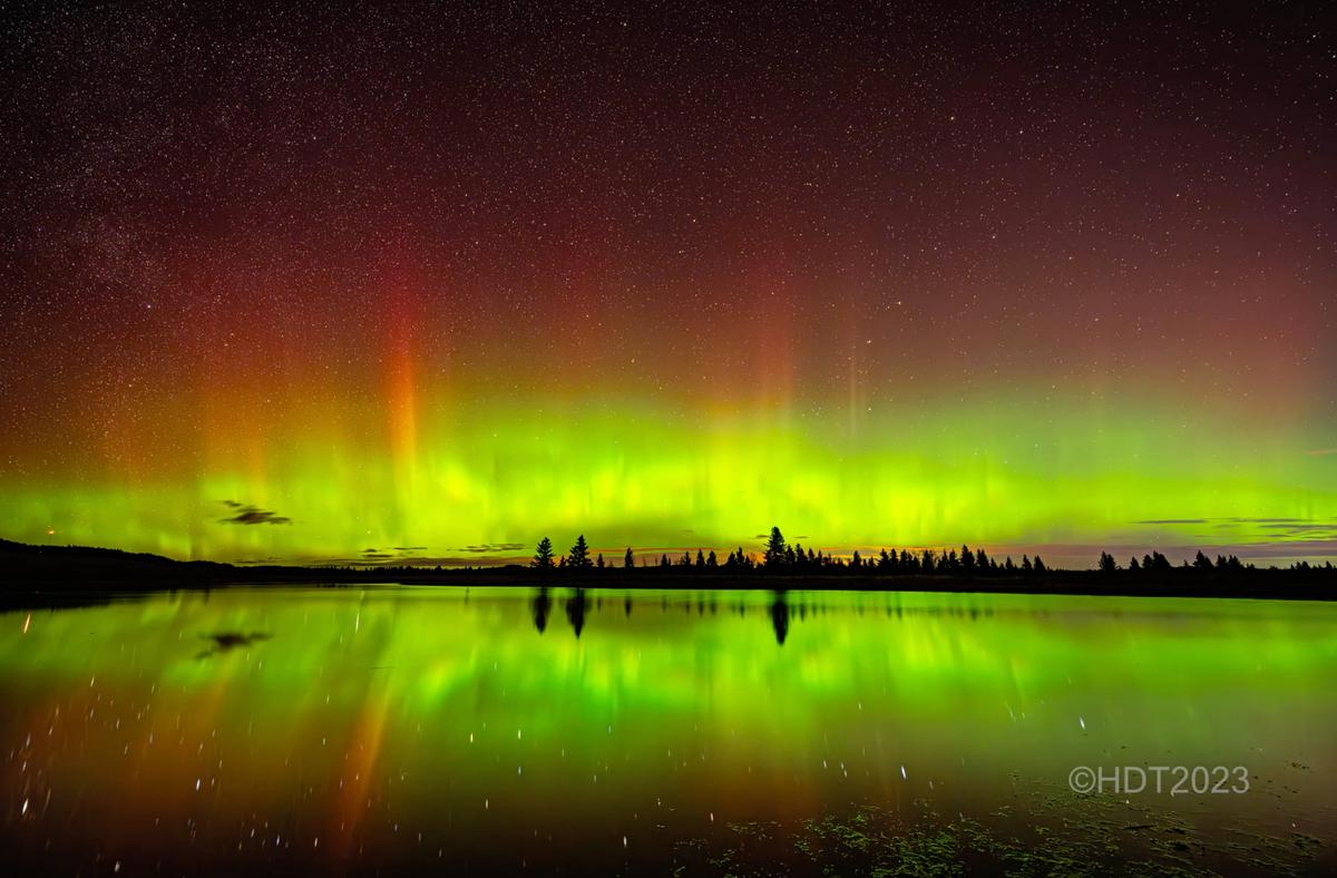 The northern lights feature a rare pumpkin-orange hue west of Calgary. (Courtesy of <a href="https://www.instagram.com/anightskyguy/">Harlan Thomas</a>)
