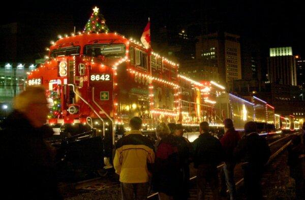 Crowds gather to greet the Canadian Pacific Railway Holiday Train as it pulls in at the depot in St. Paul, Minn., on Dec. 9, 2001. The train, with 4,000 red, white, and blue lights, left Chicago a day earlier and is bound for Moose Jaw, Sask., raising awareness and donations for food shelves along the way. (AP Photo/Janet Hostetter)