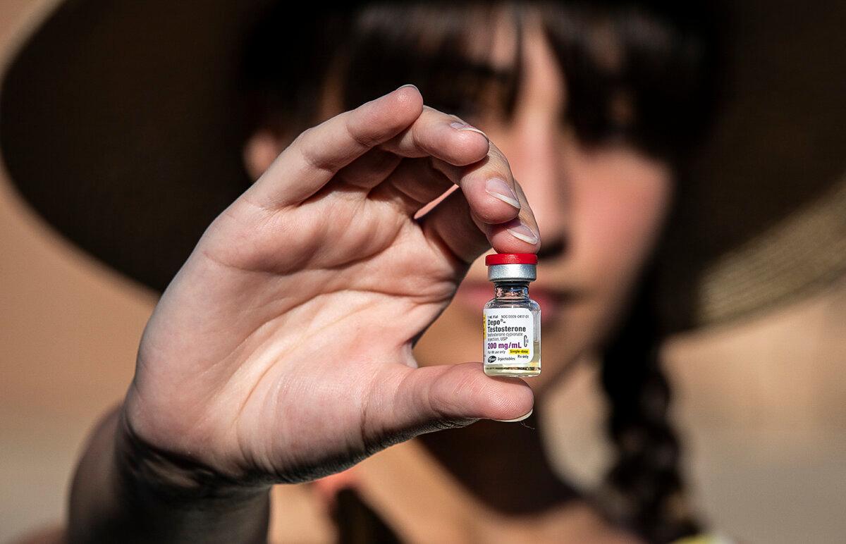 Chloe Cole, who regrets her transgender procedures as a minor, holds testosterone medication used for gender transitioning in Northern California on Aug. 26, 2022. (John Fredricks/The Epoch Times)