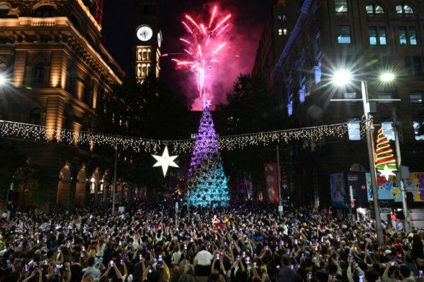 People gather to watch a fireworks display during the lighting of a Christmas tree at Martin Palace in Sydney, on Nov. 30, 2023. (Saeed Khan/AFP via Getty Images)