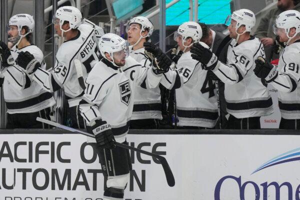 Los Angeles Kings center Anze Kopitar, foreground, is congratulated by teammates after scoring against the San Jose Sharks during the first period of an NHL hockey game in San Jose, Calif., on Dec. 19, 2023. (Jeff Chiu/AP Photo)