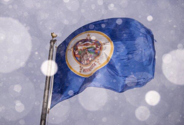 A Minnesota flag blows in the wind and snow in Minneapolis, Minn., on Dec. 23, 2020. (Stephen Maturen/Getty Images)