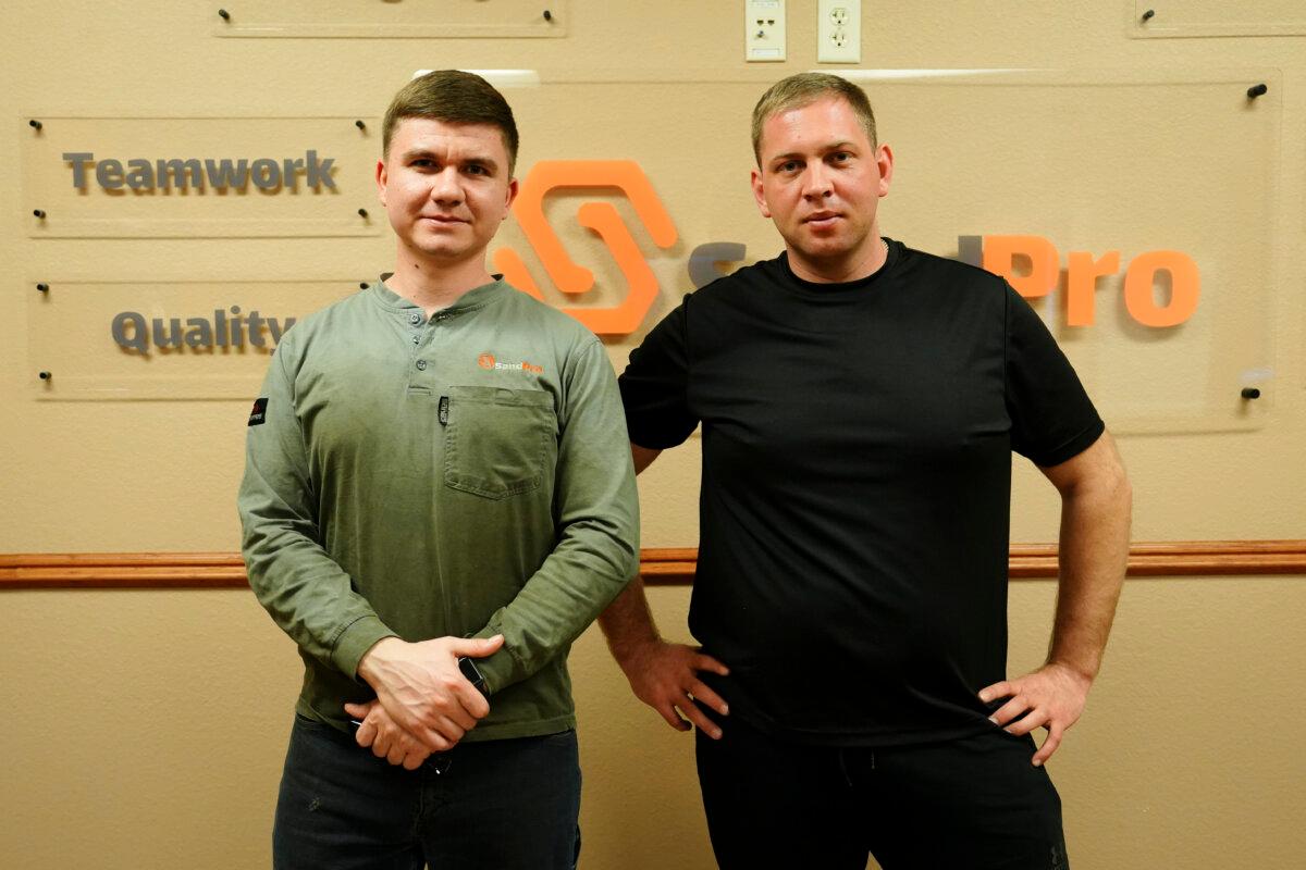Andrii Navrotskyi (L), from central Ukraine, and Dmytro Tupytsia, from a town near Odesa, who are working at SandPro LLC in Berthold, N.D., won't enjoy Christmas much this year, separated from families with their nation embroiled in an existential war. (Madalina Vasiliu/The Epoch Times)