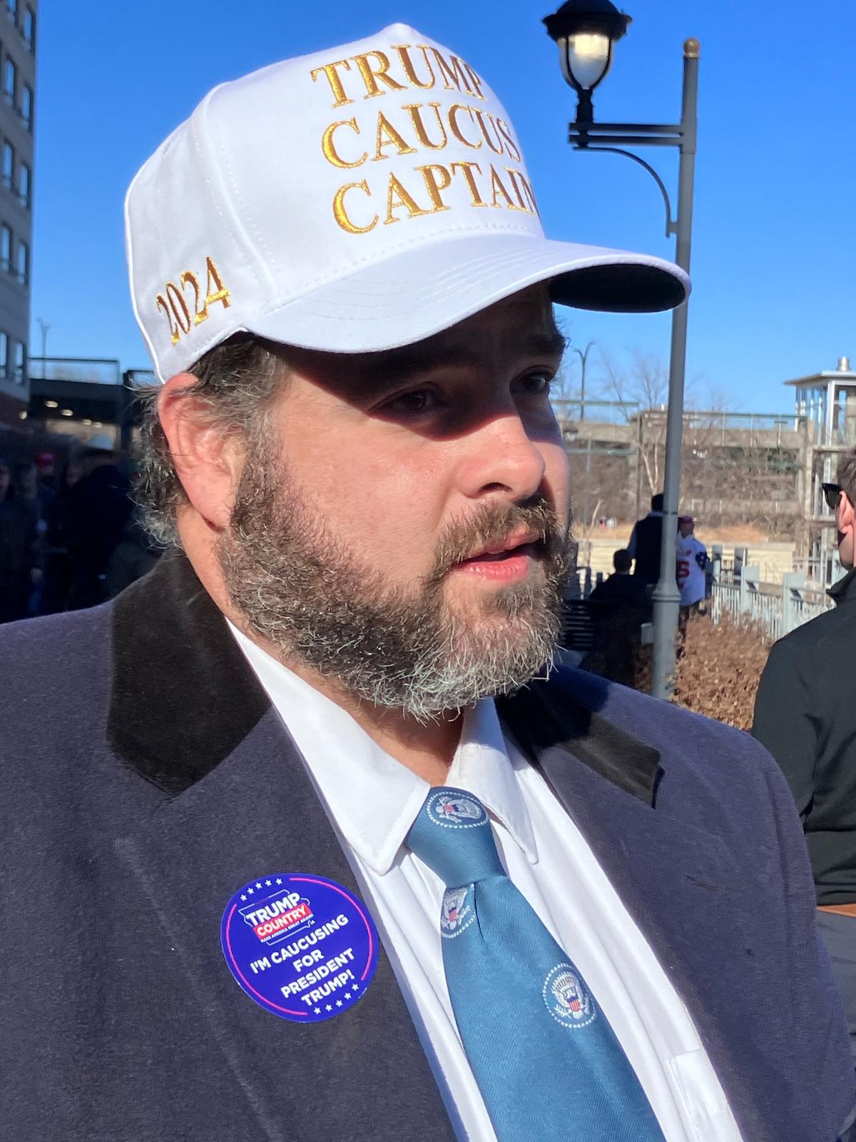 Nathaniel Gavronsky of Wayne County, Iowa, wears a "Trump Caucus Captain" hat outside a commit-to-caucus rally for former President Donald Trump in Coralville, Iowa, on Dec. 13, 2023. (Janice Hisle/The Epoch Times)