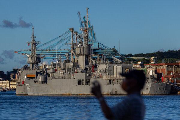 A man takes picture at the harbor where Taiwanese Navy warships are anchored in Keelung, Taiwan, on Aug. 7, 2022.(Annabelle Chih/Getty Images)